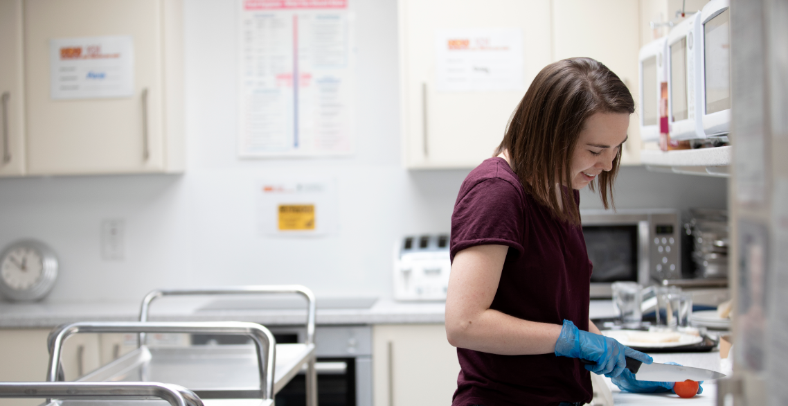 Woman using the Nutrition and Behaviour Unit kitchen to prepare for an experiment. 