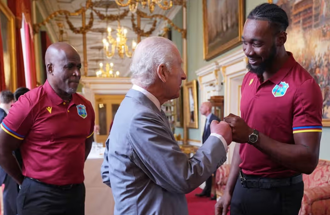 King Charles fist bumps Mikyle Louis. If the monarch had refused, ‘it would have made him look very stupid and old’, said an etiquette critic. Photograph: Yui Mok/AP