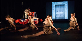 Four female students dancing on stage.