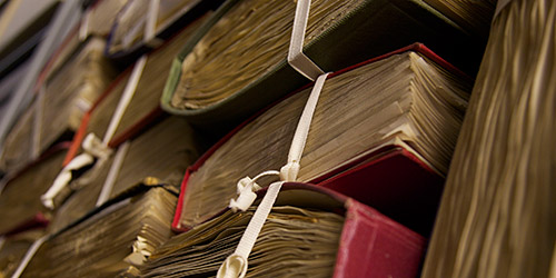 Several books bound in tape stacked on top of each other.